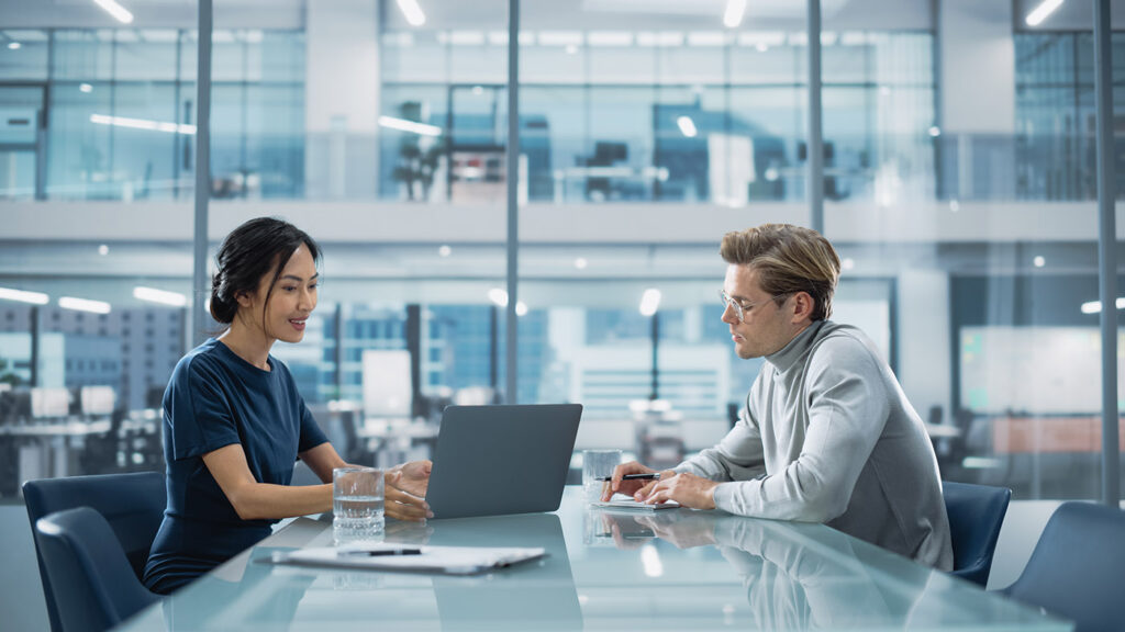 Multiethnic Diverse Office Conference Room Meeting: Team of Two Creative Entrepreneurs Talk, Discuss Growth Strategy. Stylish Young Businesspeople work on Investment and Marketing Projects.