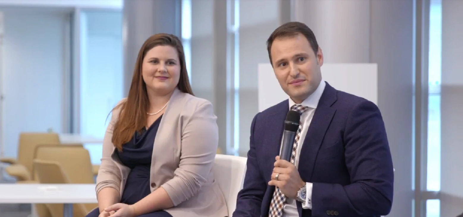 A Man And Woman Speaking At A Keynote