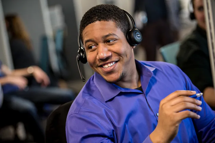 Man With Headset Smiling Leaning To The Side