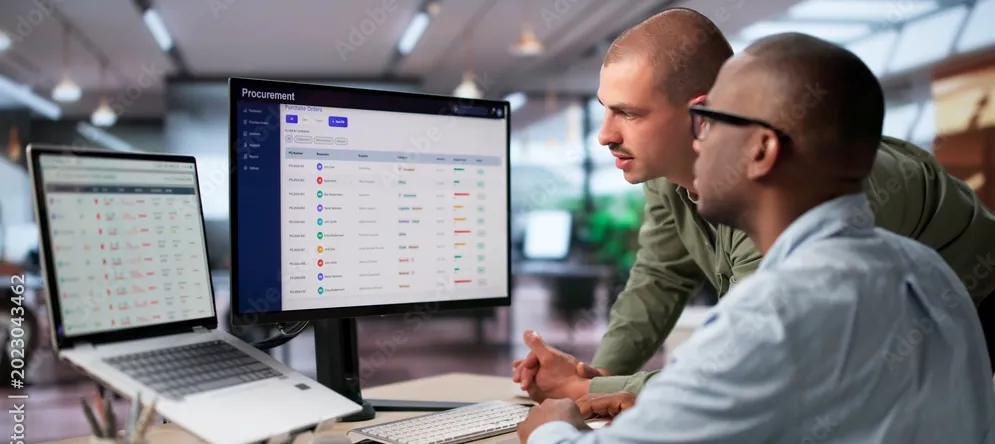 Office Workers Collaberating At Computer Monitor Cropped