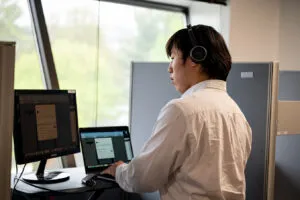 Deng selling outside the box on a headset